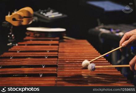 A man playing a marimba on a concert stage in the netherlands. A man playing a marimba on a concert stage
