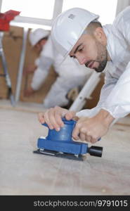 a man polishing the floor