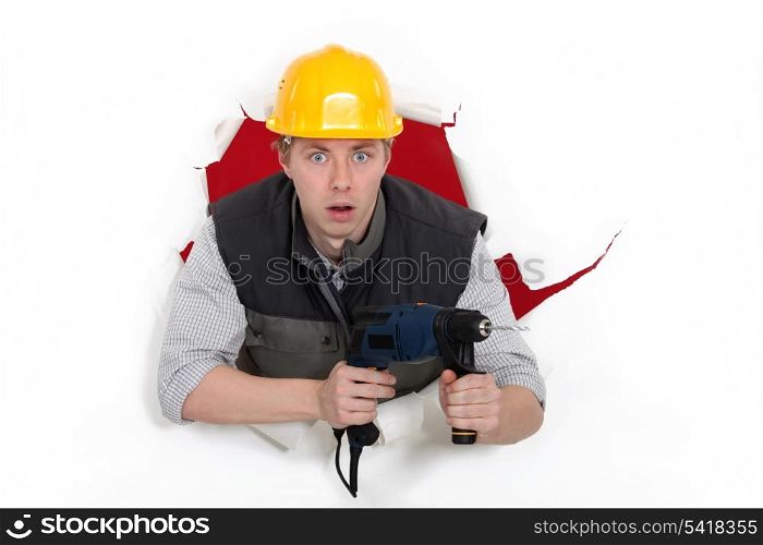 A man popping through the wall with a drill.