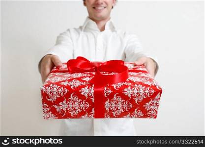 A man presenting a christmas present