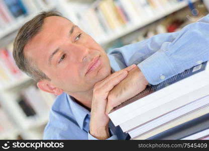a man resting on books