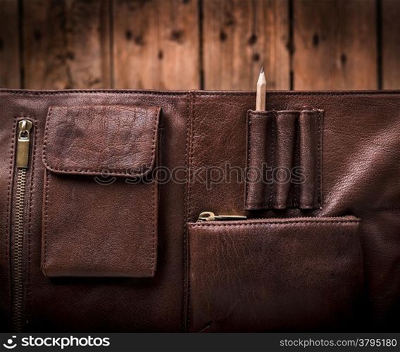A man&rsquo;s business briefcase bag, leather satchel with a pencil