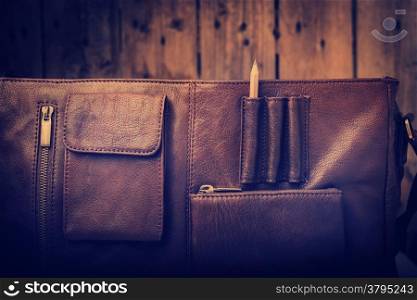 A man&rsquo;s business briefcase bag, leather satchel with a pencil for creative business