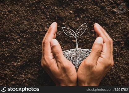 A man&rsquo;s hand is planting a tree in his imagination, an idea about the environment.