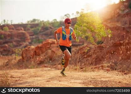 A man Runner of Trail . and athlete&rsquo;s feet wearing sports shoes for trail running in the mountains