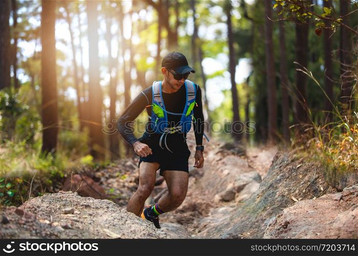 A man Runner of Trail . and athlete&rsquo;s feet wearing sports shoes for trail running in the forest