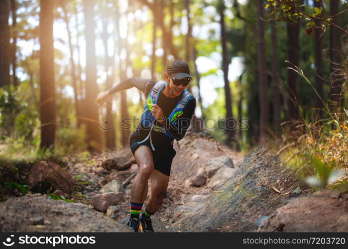 A man Runner of Trail . and athlete&rsquo;s feet wearing sports shoes for trail running in the forest