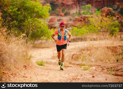 A man Runner of Trail . and athlete&rsquo;s feet wearing sports shoes for trail running in the mountains