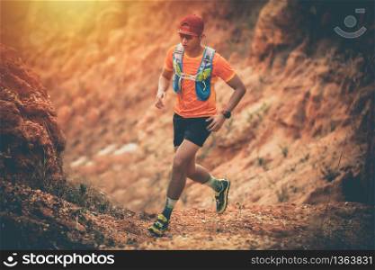 A man Runner of Trail and athlete&rsquo;s feet wearing sports shoes for trail running in the mountain