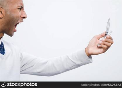 A man shouting at a cell phone