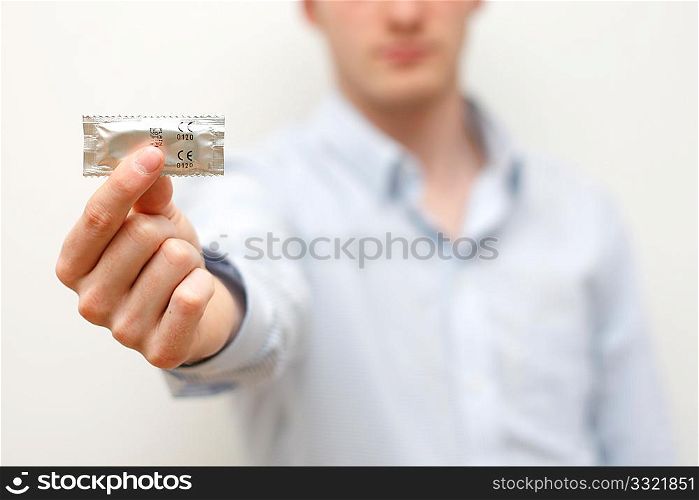 A man showing a condom