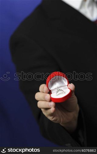 A man showing a diamond ring, can be used as wedding, birthday, anniversary or valentine concept