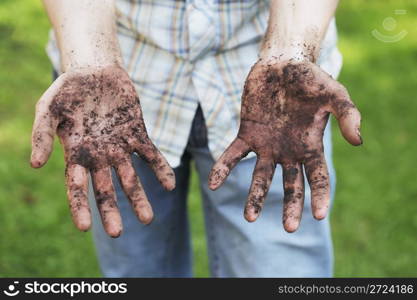 A Man showing dirty hands after gardening work