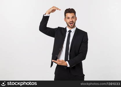 A man shows with his hands a large size on an isolated background.. A man shows with his hands a large size on an isolated background