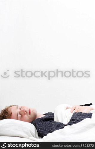 A man sleeping in his pyjamas