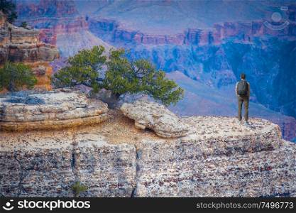 a man stands near a cliff in the Grand Canyon. USA.