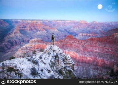 A man stands on the edge of the Grand Canyon. United States.