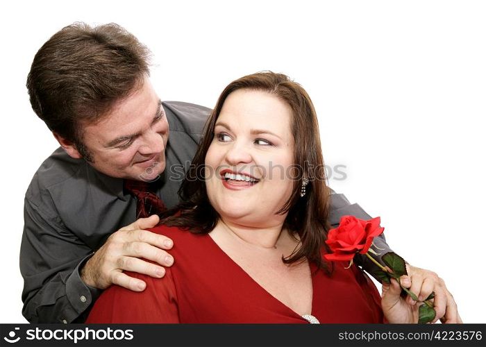 A man surprises his date with a red rose. Isolated on white.