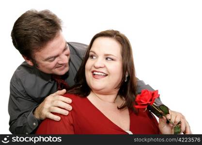 A man surprises his date with a red rose. Isolated on white.
