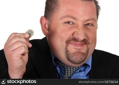 a man taking an euro coin and having a smirk