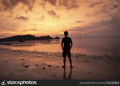 A man thoughtful on beach at sunset