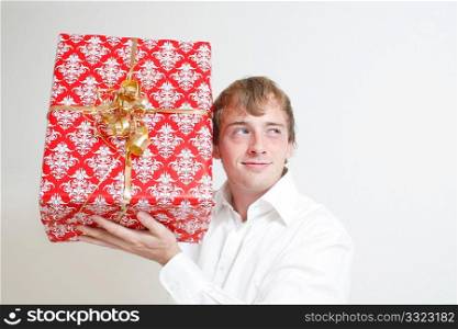 A man trying to guess a present