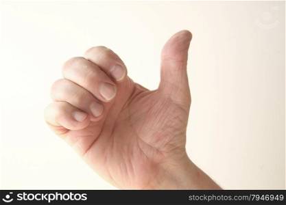 A man uses his hand in a gesture that has several meanings.