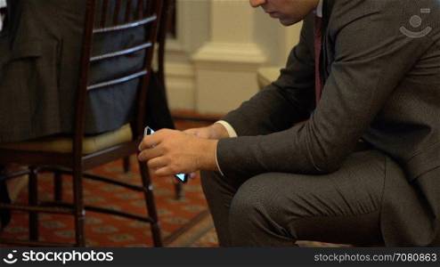 A man uses his phone during a business event
