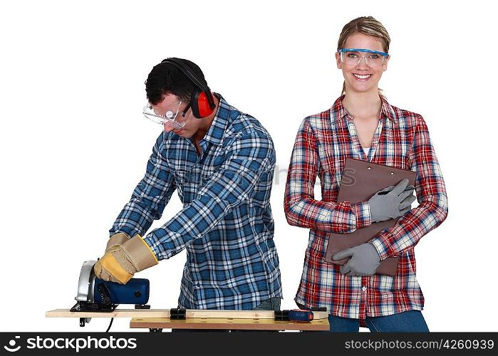 a man using a circular saw and a woman