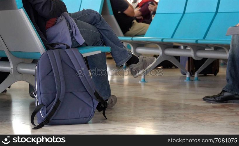 A man waits in a terminal to make a flight