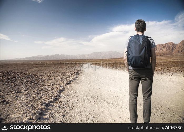 A man walks among the rocks of the Andes in the Nazca desert