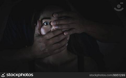 A man who covers his mouth women with his hand Human trafficking concept Violence victims