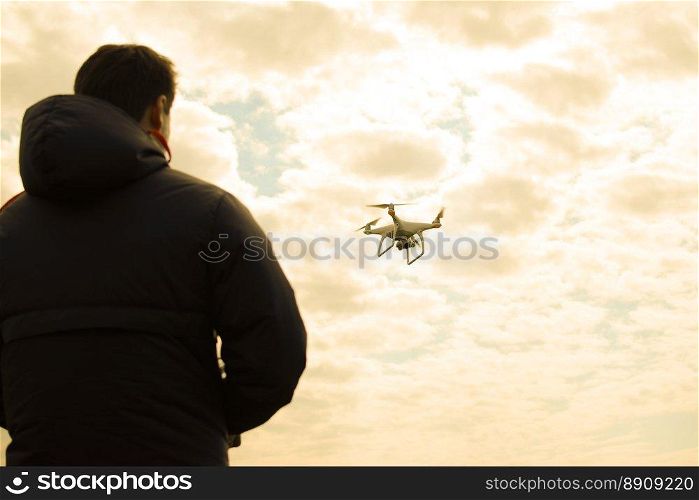 A man with a remote control in his hands. Controlling the flight of the drone against the sky. Phantom. A man with a remote control in his hands. Controlling the flight of the drone against the sky. Phantom.