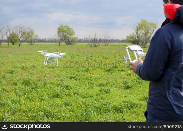 A man with a remote control in his hands. Flight control of the drone. Phantom.. A man with a remote control in his hands. Flight control of the drone. Phantom