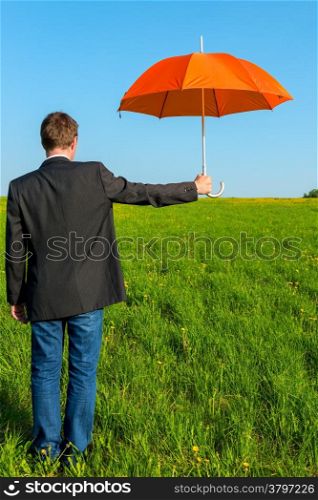 a man with an umbrella ready to shelter from the rain