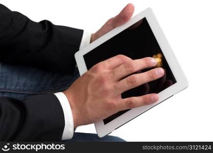 A Man with blue jeans working on a tablet pc with he&rsquo;s hand