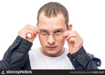 a man with poor eyesight correcting glasses isolated