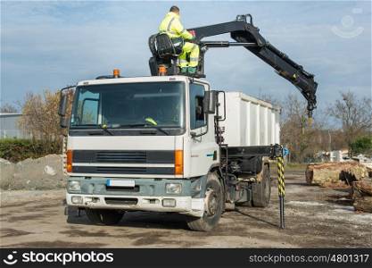 a man working on a lorry outdoors