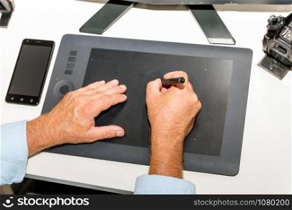 a man working on his graphics tablet