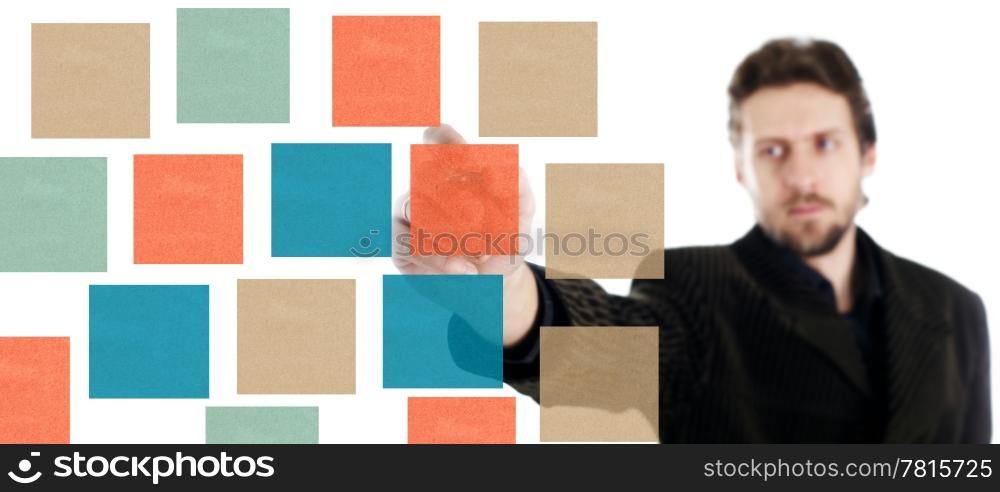A man writing something on color papers