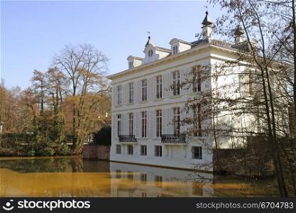 A mansion surrounded by a moat