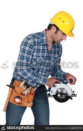 A manual worker with a circular saw.
