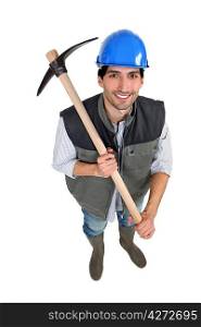A manual worker with a pickaxe.