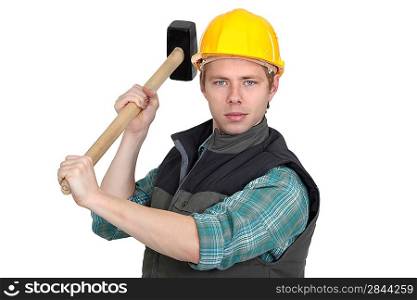 A manual worker with a sledgehammer.