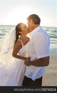 A married couple, bride and groom, kissing sunset sunrise on a beautiful tropical beach