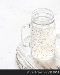 A masonn jar with basil seed drink