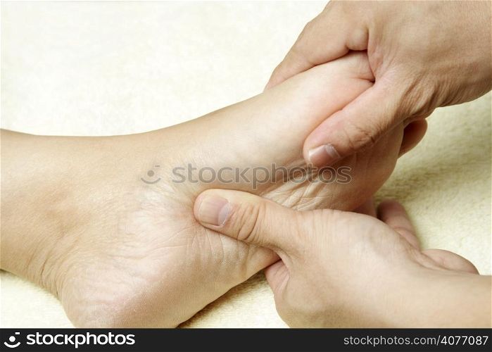 A masseuse massaging the foot of a woman