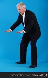 A mature businessman gesturing.