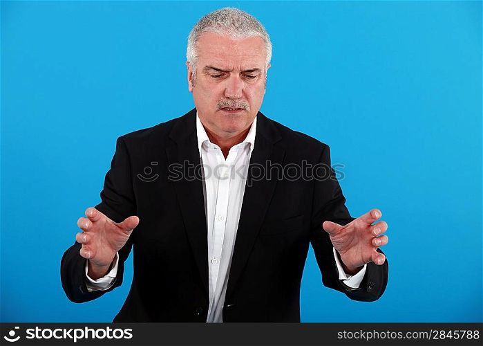 A mature businessman trying to explain something.