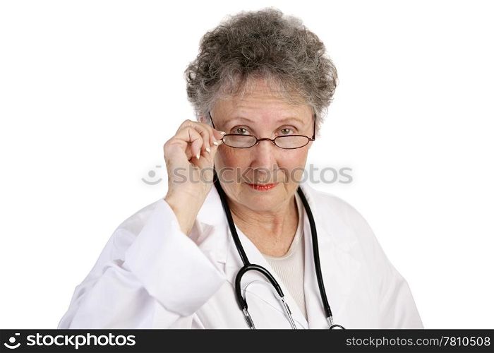 A mature female doctor staring seriously over her glasses. White background.